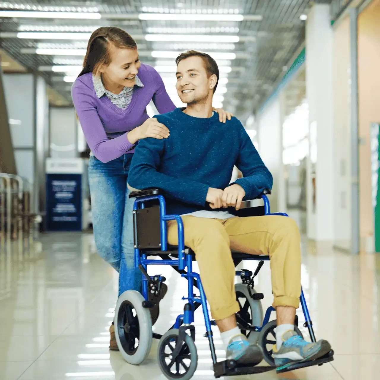 Support worker smiling with disabled man in wheelchair