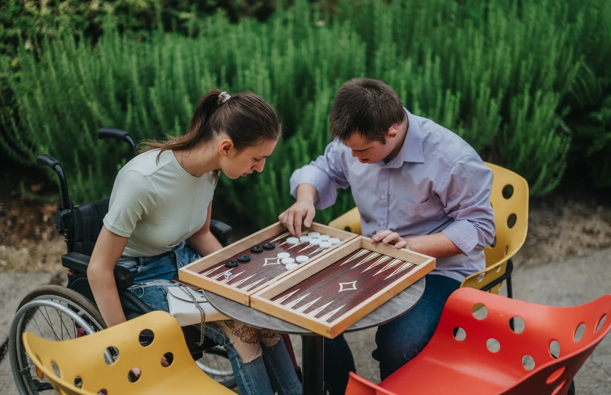 Two disabled friends playing board game