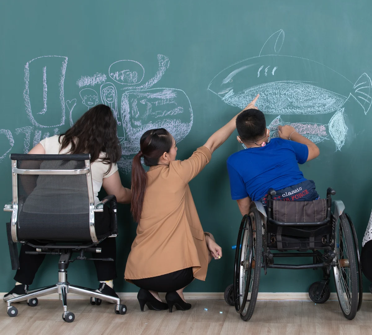 Two friends writing on chalk board with teacher