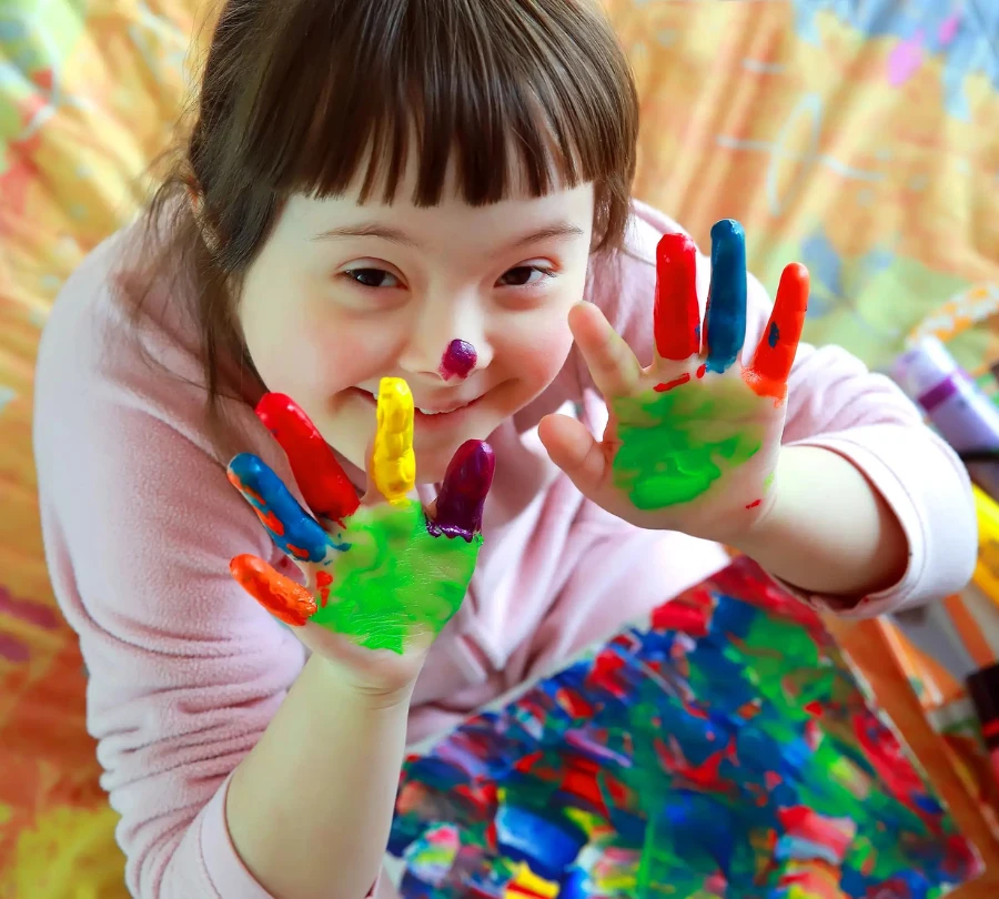 Disabled girl with paint on her hands